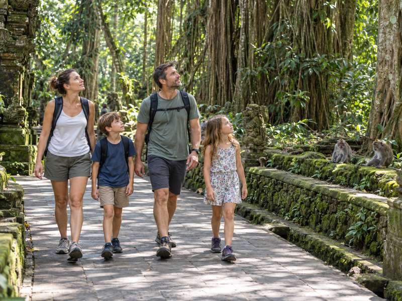 Family walking along a shaded path at Ubud Monkey Forest